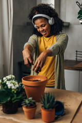 Wall Mural - Happy woman enjoys working with plants.