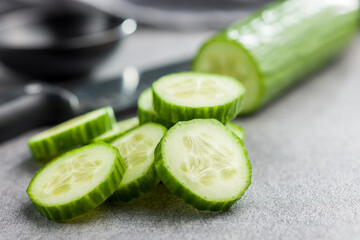 Sticker - Sliced fresh green cucumber on kitchen table.