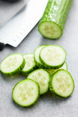 Sticker - Sliced fresh green cucumber on kitchen table.