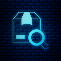 Poster - Glowing neon Search package icon isolated on brick wall background. Parcel tracking symbol. Magnifying glass and cardboard box. Logistic and delivery. Vector