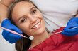 © JJ Studio - Close up of young woman having dental check up in dental office. Dentist examining a patient's teeth with dental tools - mirror and probe. Dentistry. Macro shot