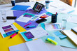 © Wavebreak Media - Tablet, smartphones and mock up visuals on busy table top at design meeting