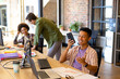 © Wavebreak Media - Happy asian male designer talking on smartphone at desk in creative office with diverse colleagues
