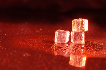 Wall Mural - Red ice cubes on black background.