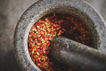 Canvas Print - Chili powder in a stone mortar