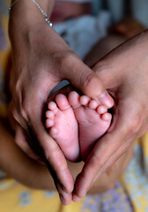 newborn baby feet in female hands