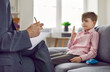 © Studio Romantic - Professional psychologist or therapist talking to child. Woman holding pencil and clipboard, asking little boy questions, and writing down his answers. Children's psychology concept