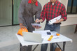 © weerachai - Team Architect planing and discuss at Construction Site with blueprint