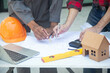 © weerachai - Team Architect planing and discuss at Construction Site with blueprint
