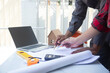 © weerachai - Team Architect planing and discuss at Construction Site with blueprint
