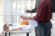 © weerachai - Engineer team consult and discuss project at Construction Site with blueprint