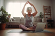 © radekcho - Happy elderly woman joining an online yoga class at home