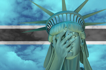 Wall Mural - Statue of Liberty. Facepalm emoji on background in colors of Botswana flag