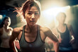© Surachetsh - Join the energetic aerobic class at the gym and be inspired by the determined Asian woman, keeping up with the upbeat routine in warm light.