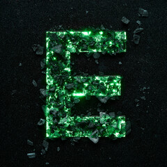 High quality photo of green colored capital letter E on a black textured background with black stones.
