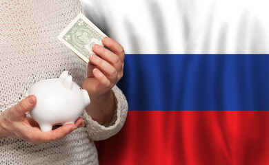 Russian woman with money bank on the background of Russia flag. Dotations, pension fund, poverty, wealth, retirement concept