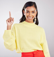 Sticker - Woman with smile in portrait, pointing with marketing and product placement on studio background. Indian female, happy with promotion and advertising, direction or choice with hand gesture and deal