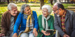 © jovannig - Four active seniors enjoying a day in the park - Generative AI