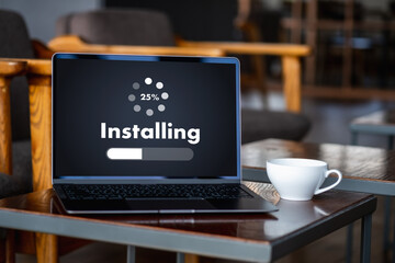 man installing Software Update On Mobile Phone And Laptop digital technology communication
