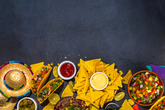 Cinco de mayo party food. Mexican holiday Cinco de mayo traditional dishes, snacks, tortilla corn chips, nachos, tacos, salsa, sauces. Friends and family feast background top view copy space