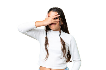 Young girl over isolated chroma key background covering eyes by hands and smiling