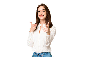 Wall Mural - Young caucasian woman over isolated chroma key background pointing to the front and smiling