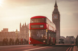 Fototapeta Do przedpokoju - Red London Bus on the Westminster Bridge and Big Ben Tower in the background.