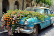 © ADDICTIVE STOCK - Generative AI illustration of rusty blue retro car with blooming flowers on hood parked on city street near old building with arched windows