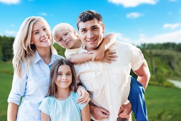 Wall Mural - Happy young family have fun in the garden