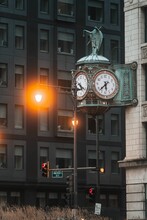 Ornate Clock And Statue Are Prominently Displayed In Front Of A Stately Building In Chicago