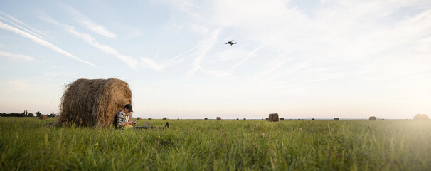 Poster - Farmer with laptop and drone on the field. Smart farming and agriculture digitalization	