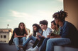 © Mihai Zaharia - Teenager friends of different races chilling together on a terrace. Generative AI