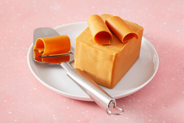 Wall Mural - Norwegian brunost traditional brown cheese block and slicer