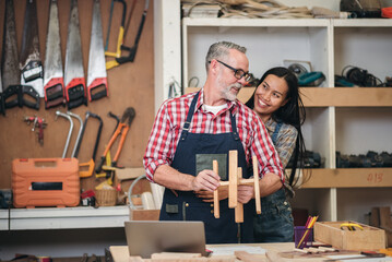 Wall Mural - Carpenter man small business owner and partner working in wood workshop, Small business entrepreneur woking together at workplace.