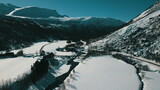 Fototapeta Morze - Aerial view of a small village in the mountains. Winter landscape.