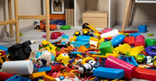 An Abundance Of Toys In The Children's Room, A Lot Of Plastic Multi-colored Parts From Designers, Spare Parts For Toys, Figurines And Cubes.