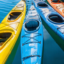 Four Colorful Kayaks Positioned In An Array.