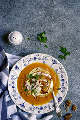 Wall Mural - Pumpkin or carrot soup with chicken and walnut. Top view with copy space.