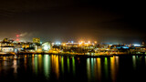 Fototapeta  - city skyline at night reflected in bay