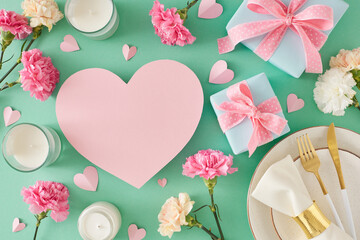 Wall Mural - Trendy Mother Day table setting idea. Top view photo of plate with cutlery napkin gift boxes candles carnation flowers hearts on turquoise background. Flat lay with blank heart for text or advert