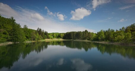 Wall Mural - Relaxation landscape of a lake in a Karandila mountain and fresh green forest, 4k video. Nature of Bulgaria in spring time.