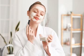 Wall Mural - Young woman with turmeric mask and brush in bathroom