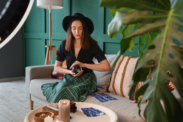 Wall Mural - Young fortune teller recording video for blog at home