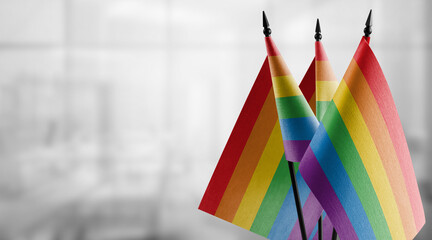 Small flags of the lgbt on an abstract blurry background