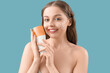 © Pixel-Shot - Beautiful naked young woman with sunscreen cream on blue background