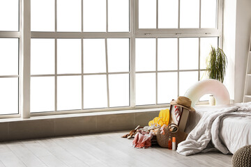 Poster - Open suitcase with beach accessories in bedroom