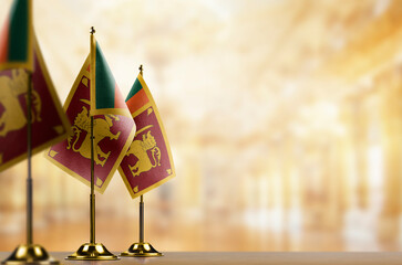 Wall Mural - Small flags of the Sri Lanka on an abstract blurry background