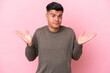 © luismolinero - Young caucasian handsome man isolated on pink background making doubts gesture