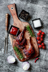 Wall Mural - grilled duck legs on a stone background