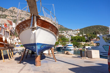 Wall Mural - White boat on stands during storage in the port during the cold season of the year Kash Turkey.